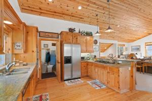 a kitchen with wooden cabinets and a stainless steel refrigerator at Cascade Woods in Tahoma