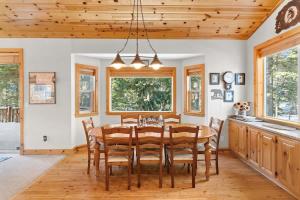 a dining room with a wooden table and chairs at Cascade Woods in Tahoma