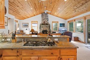 a kitchen with a stove and a living room at Cascade Woods in Tahoma