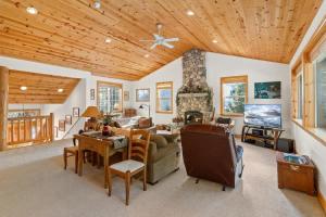 a living room with a couch and a table and a fireplace at Cascade Woods in Tahoma +37 photos