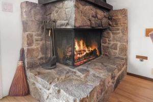 a large stone fireplace with a broom in a room at Corwin's Quarters in Kings Beach