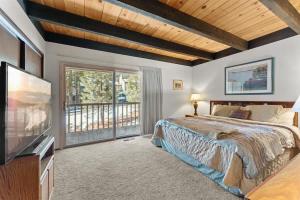 a bedroom with a large bed and a balcony at Corwin's Quarters in Kings Beach