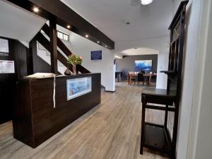 an office with a reception desk and a dining room at Beachwood Inn Melkbosstrand in Cape Town