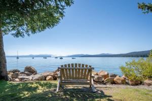 a wooden bench sitting next to a body of water at Bearfoot Bungalow in Tahoe Vista