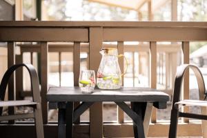 a table with a vase and two glasses on it at Bearfoot Bungalow in Tahoe Vista +30 photos