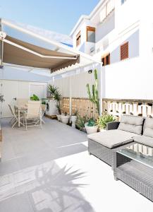an outdoor patio with furniture and a table at Playa Oliva Apartment in Playa