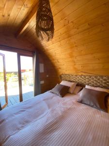 a bedroom with a large bed in a wooden ceiling at Triarca Vinum House in Sabrosa +24 photos