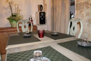 a dining room table with two chairs and a microwave at Torre Tresca B&B in Bari