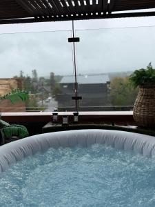 a large hot tub in a room with a window at Martina de Goñi in Pucón
