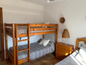 a bedroom with two bunk beds and a bed at Can Llorach in Sant Jaume d'Enveja