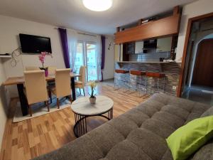 a living room with a couch and a table at Apartments Ana Kroatien Vodice in Vodice