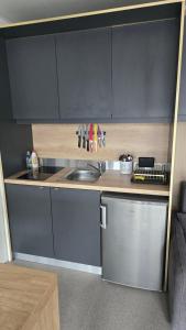a small kitchen with a sink and a dishwasher at Vila Mia 3, camp Limoni in Sukošan +47 photos