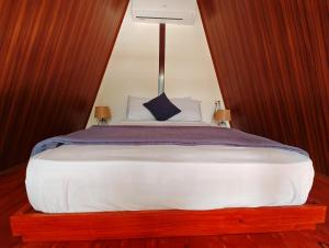 a bedroom with a large bed with a canopy at Cabañas Martina Surf Playa Guanico in Pedregal