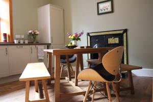 a kitchen with a table and chairs and a stove at Alexandra Apartment - stunning view in Oban