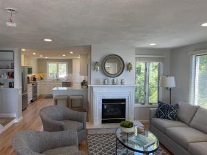 a living room with a couch and a fireplace at Great Hill in Kennebunk