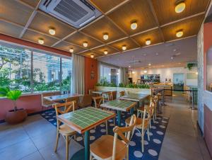 a dining room with tables and chairs in a restaurant at B&B HOTEL Santos Dumont in Rio de Janeiro