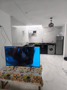 a kitchen with a table in a room at Appartement nador G in Nador