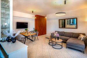 a living room with a couch and a table at Casa Di Aspa-Serene Escape with Pool near town in Rethymno