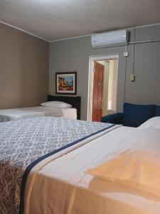 a hotel room with two beds and a window at Ultimate Freedom Bed and Breakfast in Santa Cruz