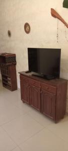 a flat screen tv sitting on top of a wooden cabinet at El Legado in San Pedro +15 photos
