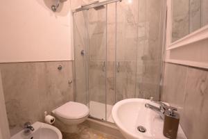 a bathroom with a shower and a toilet and a sink at Short Lets Grandi Stazioni in Bari