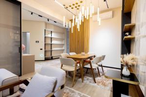 a dining room with a table and chairs at Luxury 98m2, City Boulevard View, Fountain View, Tashkent City in Tashkent