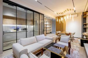 a living room with a couch and a table at Luxury 98m2, City Boulevard View, Fountain View, Tashkent City in Tashkent