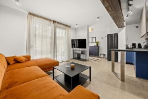 a living room with a couch and a table at Stillar Apartment near sea in Pula