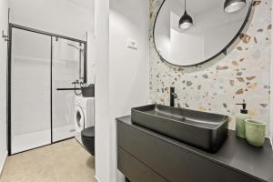 a bathroom with a black sink and a mirror at Stillar Apartment near sea in Pula +15 photos