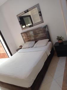 a bedroom with a bed with a mirror on the wall at Villa Catalpas in Taroudant +27 photos