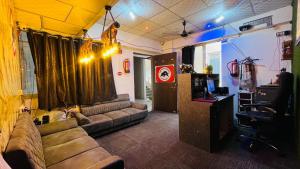 a living room with a couch and a desk at The Bull Group International in Surat +10 photos