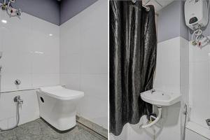 a bathroom with a toilet and a sink at The Bull Group International in Surat