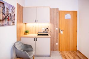 a small kitchen with a chair next to a door at Rooms Ikar in Velika Gorica