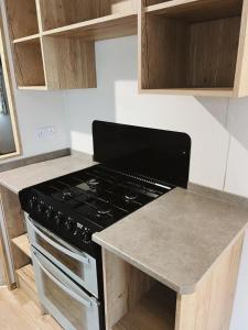 a kitchen with a stove and a counter top at St Nicolas in Girvan