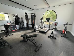 a gym with several exercise equipment in a room at The Happy Chameleon in George