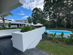 an exterior view of a house with a swimming pool at The Happy Chameleon in George