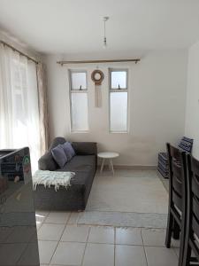 a living room with a couch and two windows at HM Royal Homes in Nairobi