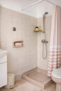 a bathroom with a tub and a toilet and a shower at Ilios Place Corfu-Near Old Town & Beaches in Kontokali +31 photos