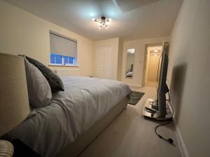 a bedroom with a bed and a flat screen tv at Haven at Chafford Hundred in West Thurrock
