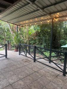 a patio with a black fence and trees at Villa Luis in Boquete
