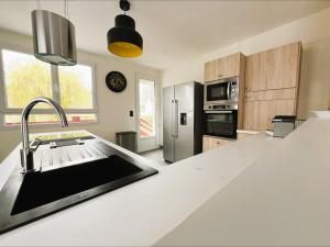 a kitchen with a sink and a refrigerator at Villa Margil in Le Tréport