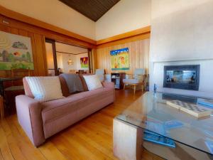 a living room with a couch and a fireplace at Amadeus Hotel Boutique in Frutillar