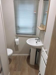 a bathroom with a sink and a toilet at St Nicolas in Girvan +10 photos