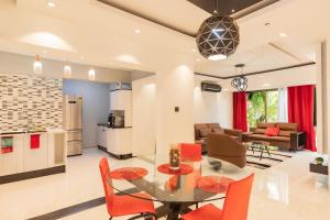 a kitchen and living room with a glass table and chairs at Aion Suites 301 in North Legon +33 photos