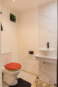 a bathroom with a toilet and a sink at Aion Suites 301 in North Legon