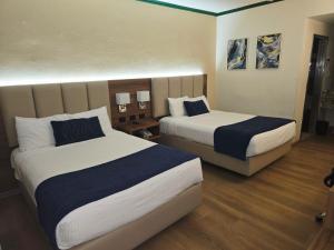 a hotel room with two beds in a room at Las Misiones Hotel in Monclova +8 photos