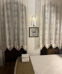 a bedroom with a bed and a window with curtains at Bademli Ancanoz Hotel in Dikili +7 photos