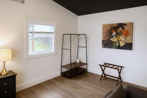 a room with a mirror and a chair and a window at Okangan Sunset Bungalow in Vernon