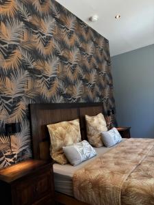 a bedroom with a bed with a patterned wall at Villa Liberty in Entraigues-sur-la-Sorgue +60 photos