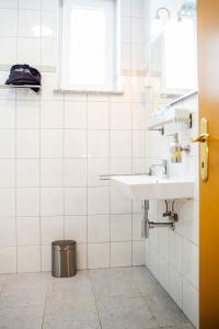 a bathroom with a sink and a window at Rooms Ikar in Velika Gorica +33 photos